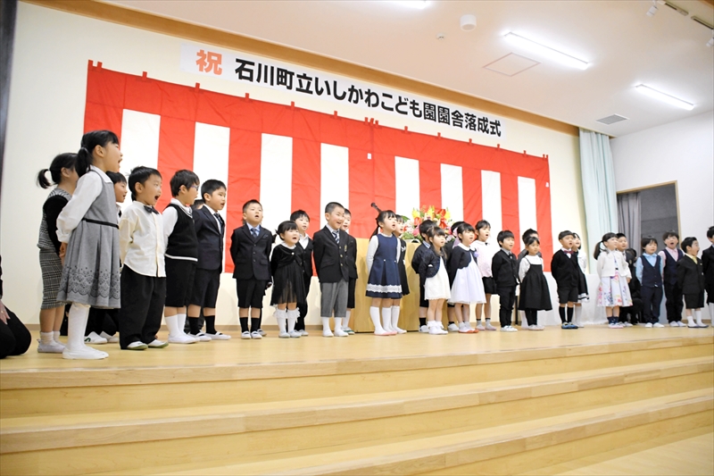 落成式で園歌を大きな声で披露する園児